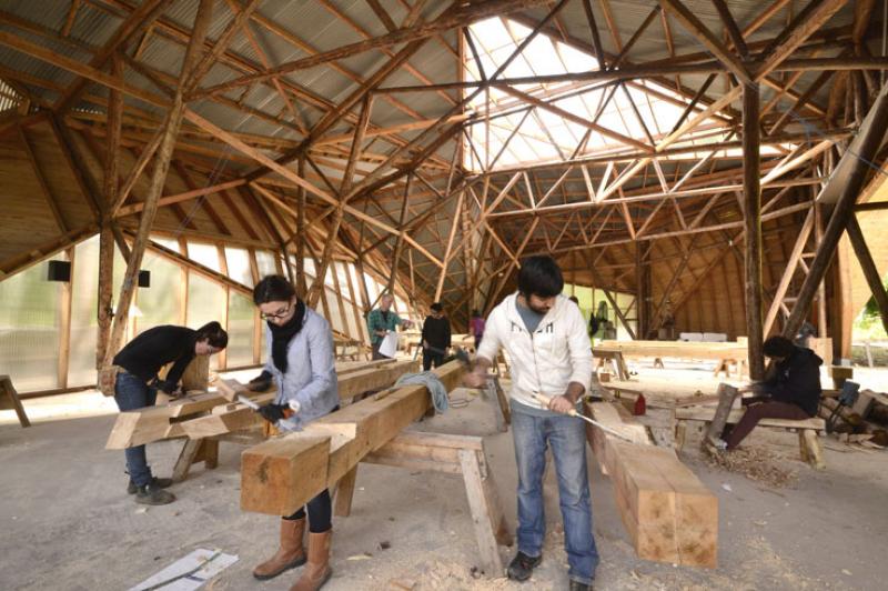 New student accomodation building under construction in Big Shed - Abdullah Omar and Bojana Grebenar preparing mortise and tenon joints. 